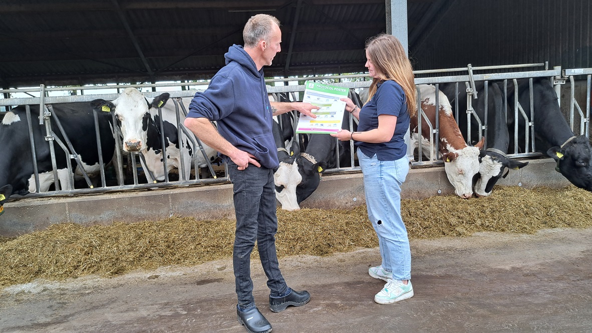 Regelmatig komt Lisa Verhoeven (rechts) van AHV langs op het bedrijf. Hier neemt ze met de melkveehouder een protocolposter door die AHV ter ondersteuning aanbiedt.